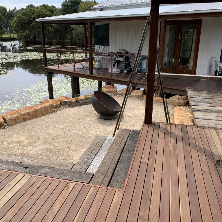 A landscape design showing a timber deck overlooking a pond.