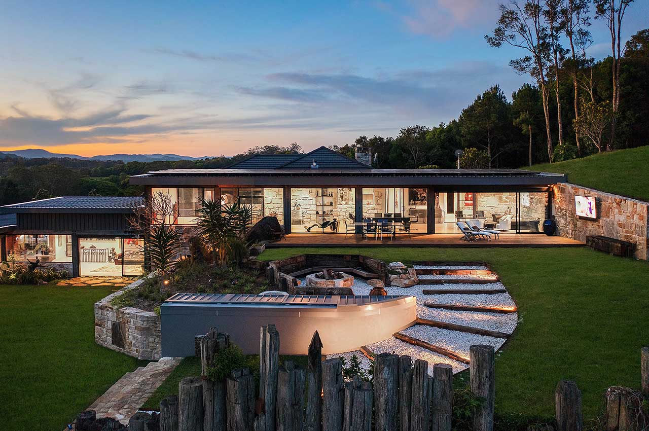 View of property from an elevated angle, showcasing a fire-pit with spiralling timber and stone pathway.