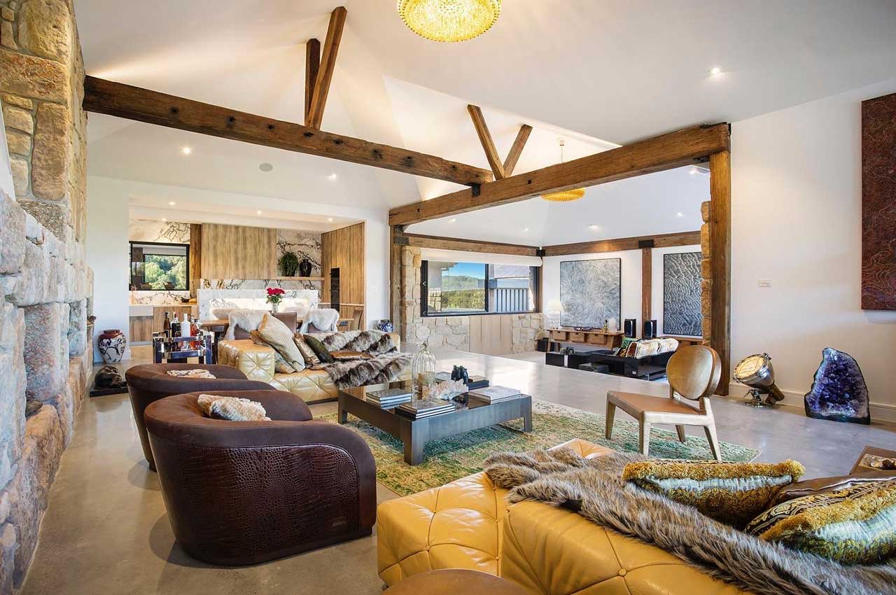 Image of Longwood Estate Byron Bay property lounge-room, showing timber features and luxurious furnishings.